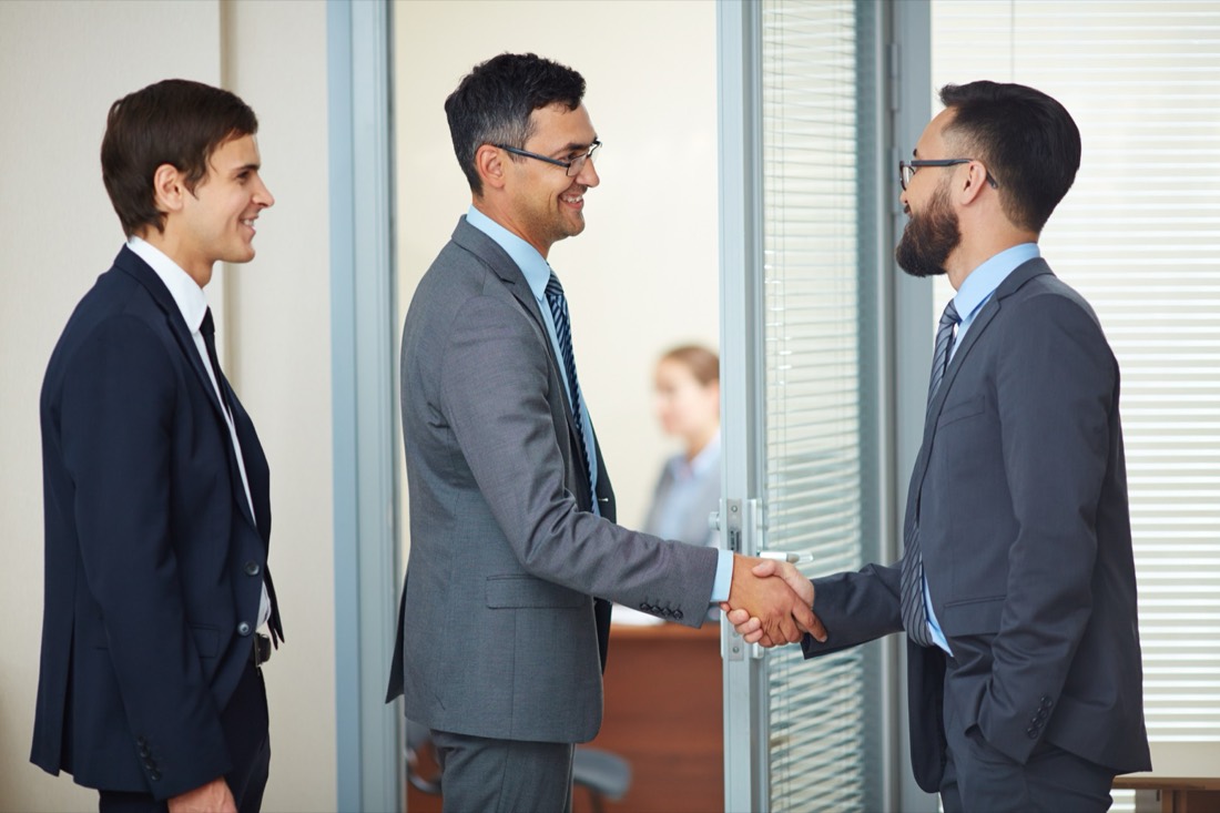 Two colleagues shaking hands in an office